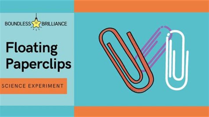 What causes the surface tension that allows a paperclip to float on water